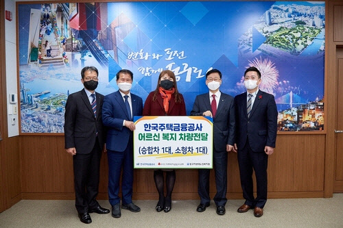 한국주택금융공사는 부산시 동구청에서 코로나19 조기극복을 위해 임원진 급여 반납분을 재원으로 구매한 '어르신 복지 차량'을 26일 전달했다. 이정환 한국주택금융공사 사장(오른쪽 두 번째), 최형욱 동구청장(왼쪽 두 번째), 이은숙 자성대노인복지관장(가운데)과 관계자들이 기념촬영을 하고 있다. 주금공 제공